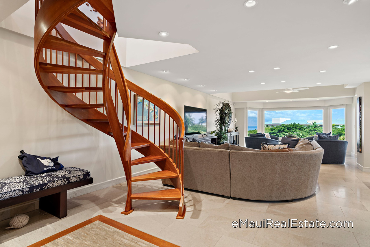 Graceful spiral staircase connects the living room with the loft bedroom